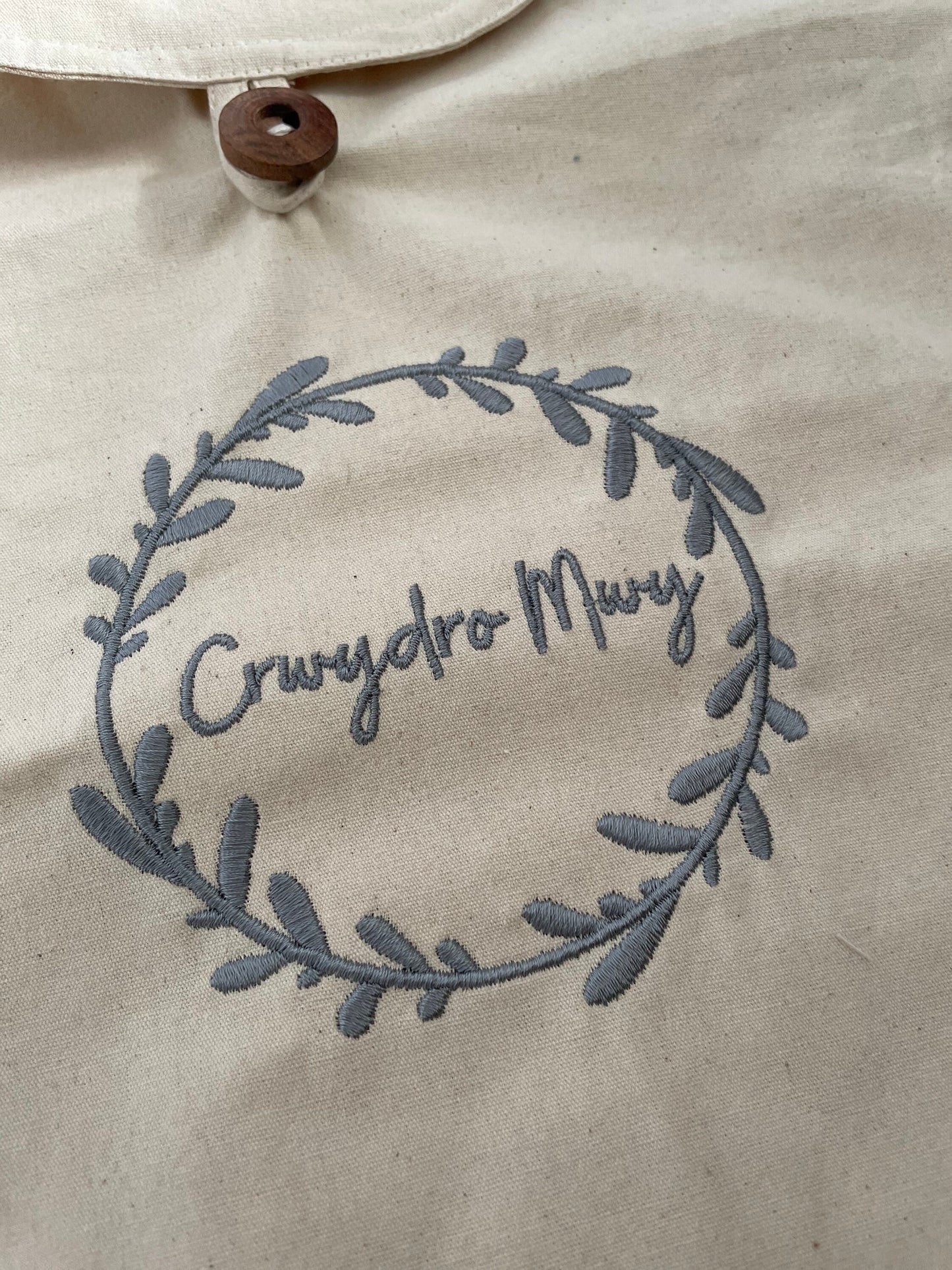 Crwydro Mwy (Wander More) cotton drawstring backpack. Welsh language